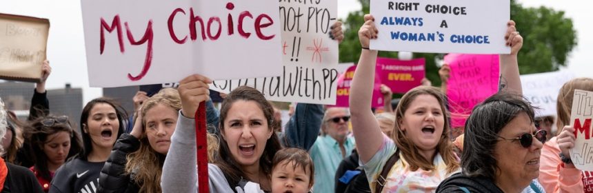 Protesters holding signs reading, "My Body My Choice"