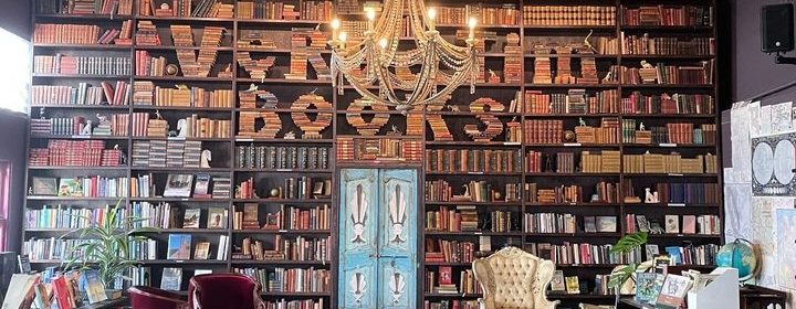 Large wall of bookshelves with "Verbatim Books" spelled out