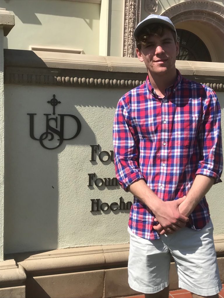 Male standing in front of University of San Diego entrance