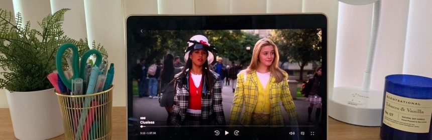 Open laptop on desk with scene from "Clueless" playing