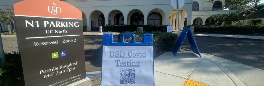 Sign placed on campus reading "USD Covid Testing" directing students to the testing center