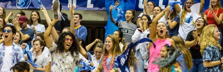 Large group of students jumping and cheering on bleachers