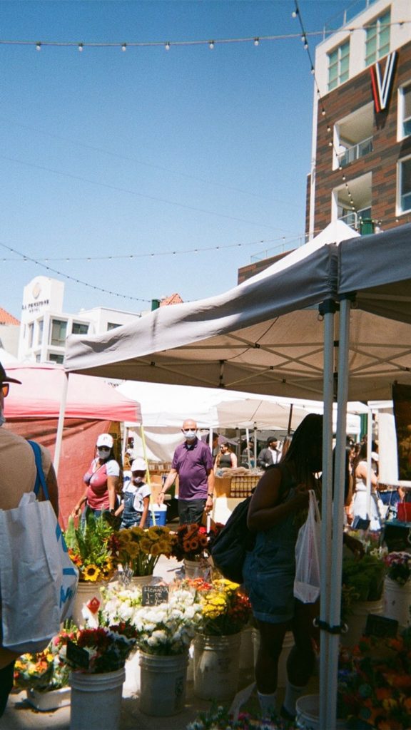 Outdoor farmers market with multiple booths set up
