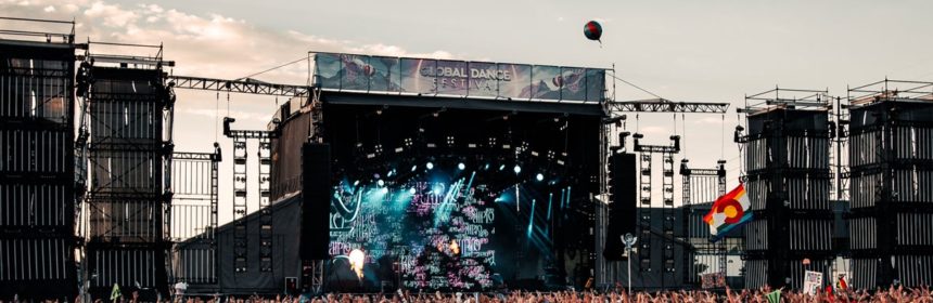 Wide angle image of music festival packed with people