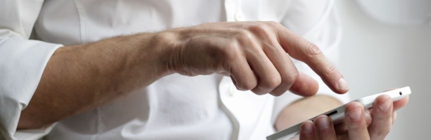 Close up view of person's hands using their cell phone