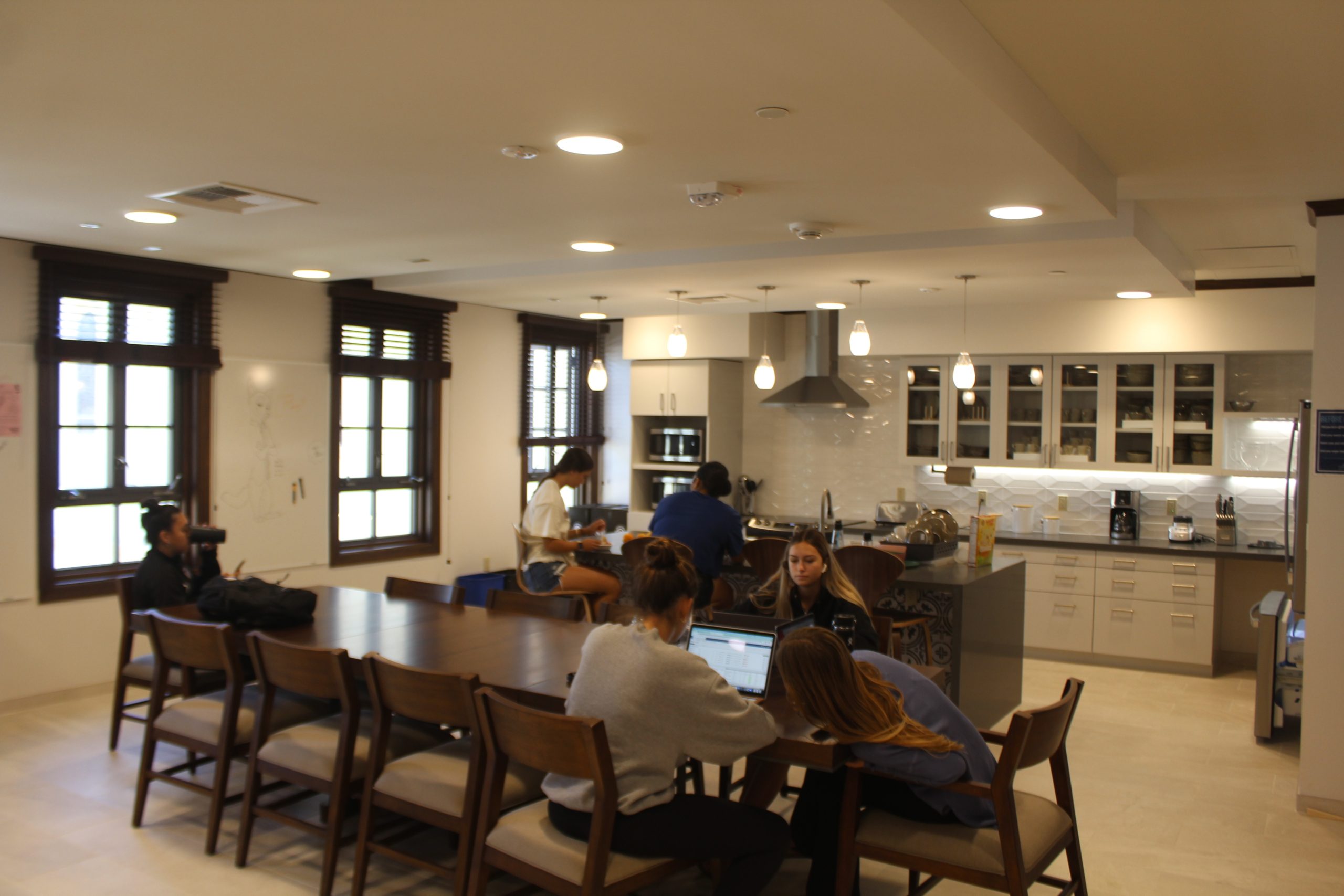 Indoor kitchen area with students sitting around large table