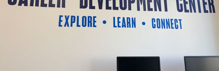 Wall with "Career Development Center; Explore, Learn, Connect" printed on it