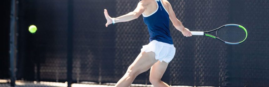 Female tennis player about to hit the ball during a match