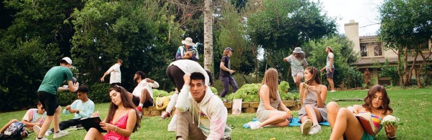 People in colorful outfits laying on a patch of grass