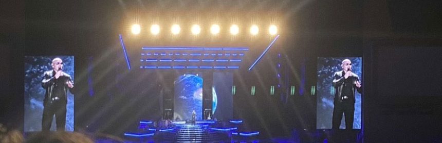Photo of large lit-up, outdoor concert stage with crowd
