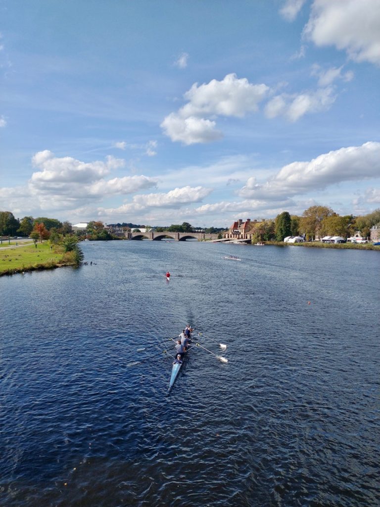 Large body of water with rowing teams in boats