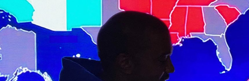 Silhouette of Kanye West standing in front of electoral college map of the USA