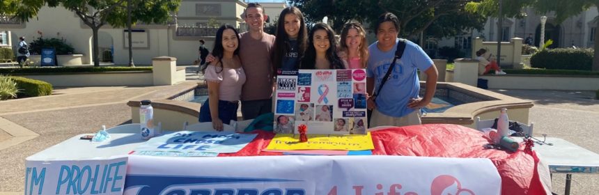 Table with students and banner reading "Toreros 4 Life"