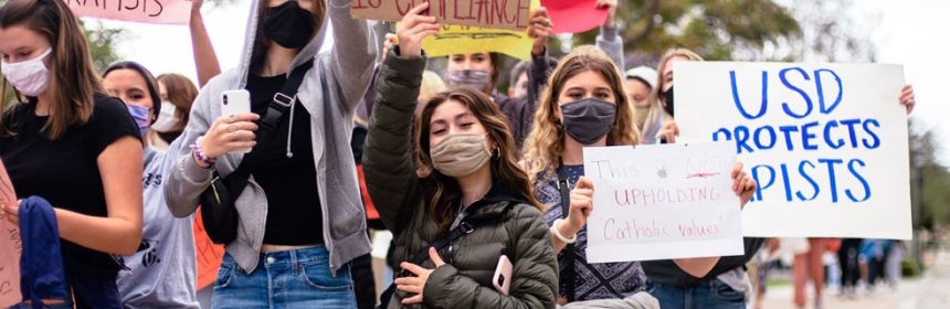 Students holding up signs in protest