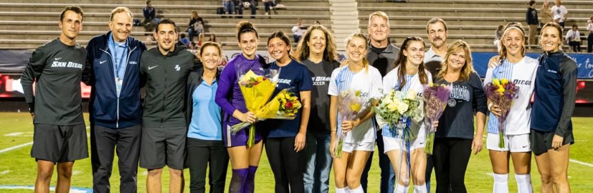 Women's soccer players and supporters after a game