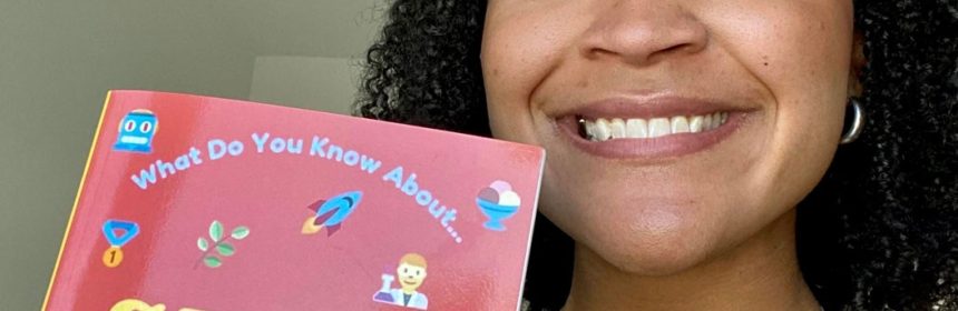 Student author of STEM children's book holding up book