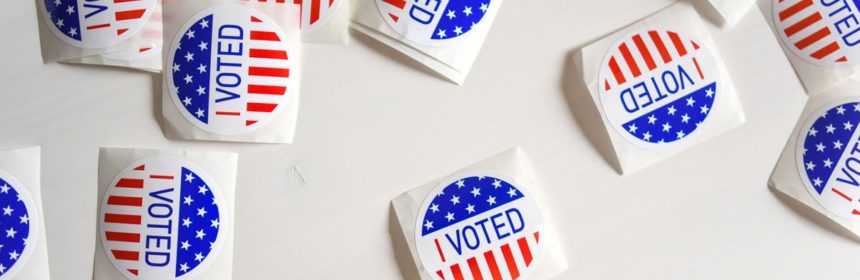 Many "I Voted" stickers on a table