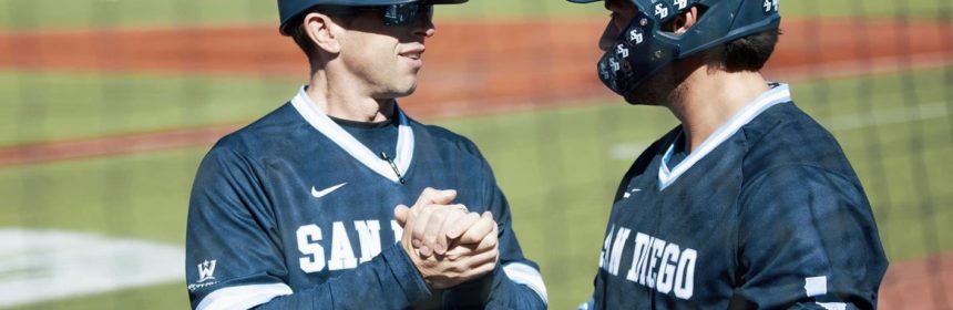 Two baseball players shaking hands during a game