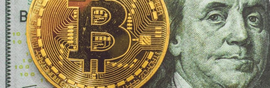 Graphic of bitcoin over 100 dollar bill