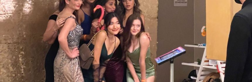 Group of women taking photo at a photo booth