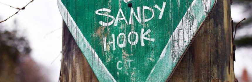 Wooden heart reading "Sandy Hook" nailed to a tree