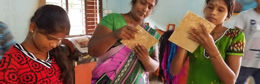 Three Sri Lankan women inspecting products