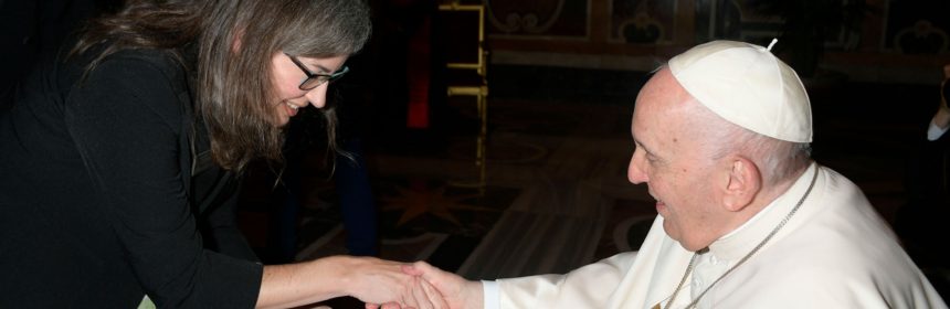 woman shaking hands with the pope