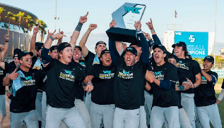 group of boys stand excited holding trophy up in the air